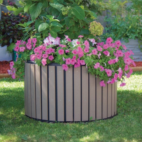 Decorative commercial self-watering planter with flowering plants for low-maintenance landscaping in parks and streetscapes.